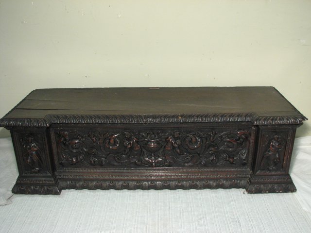 CONTINENTAL 18TH C CARVED WALNUT CHEST: An 18th century carved wood blanket style chest. Elaborately carved details with a mahogany finish and original hand wrought hardware. Condition: minor wormage to wood, some splitting from age, scatte