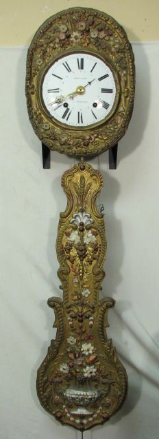 19TH C FRENCH REPOUSSE BRASS WAG-ON-WALL CLOCK: A 19th century French repousse brass wag-on-the-wall clock. Hammered metal clock housing, with a hand painted repousse brass border and pendulum decoration. White enamel face, with black roman numeral