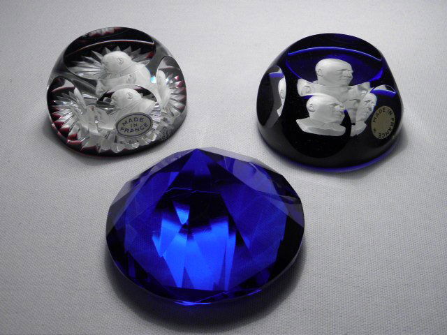 THREE CUT GLASS PAPERWEIGHTS: BACCARAT, ETC.: Lot of three cut glass paperweights. Includes (2) Baccarat carved sulphide cameo paperweights (Sam Rayburn and Pope John XXIII), and a diamond shaped cut blue glass weight. Baccarat paperweights are b