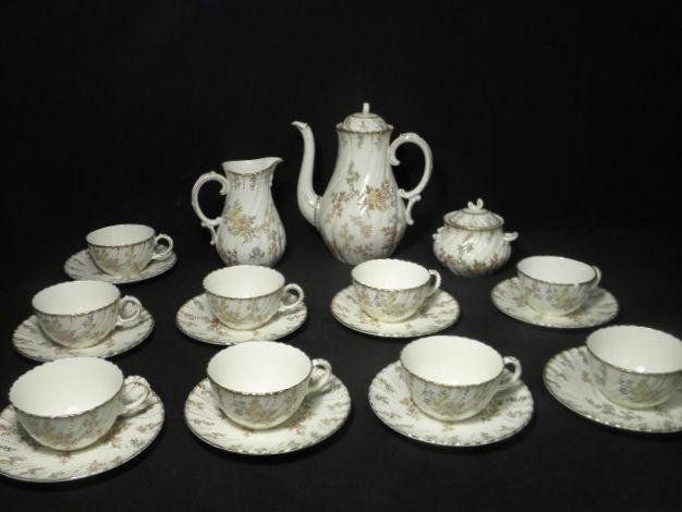 SARREGUEMINES FRENCH FLORAL PORCELAIN TEA SET: 21 PCS: Sarreguemines French floral porcelain tea set. Includes 21 total pieces: (9) 7" saucers, (9) teacups with a diameter of 4.25", a 10.25" tall teapot, a 4.75" tall lidded sugar dish, and a 7" tall cream