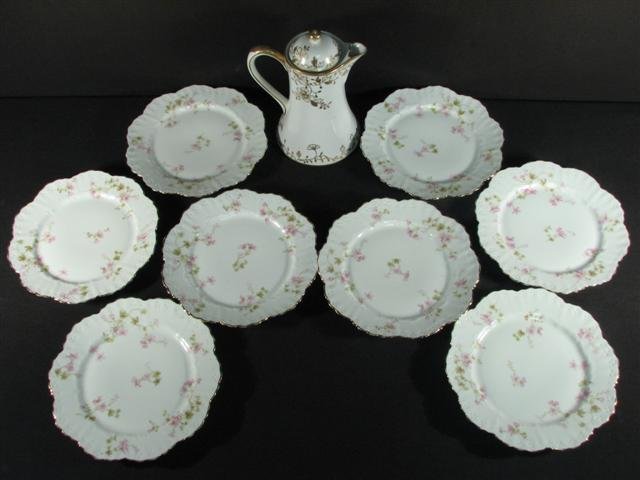 EIGHT LIMOGES PORCELAIN PLATES & A NIPPON CHOCOLATE POT: Lot of assorted Limoges French porcelain plates and a Nippon gold moriage decorated chocolate pot. Plates measure 9.25" in diameter, have a ribbed and gilt rim, and floral sprays throughout. Each plat