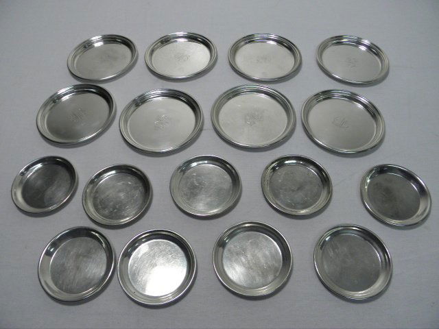 SEVENTEEN STERLING SILVER COASTERS: 27.4 TROY: Lot of seventeen sterling silver coasters. Includes (9) 2.65" diameter coasters, and (8) 3.6" diameter coasters (monogrammed in center). All pieces are stamped on base "Sterling". Condition: minor pat
