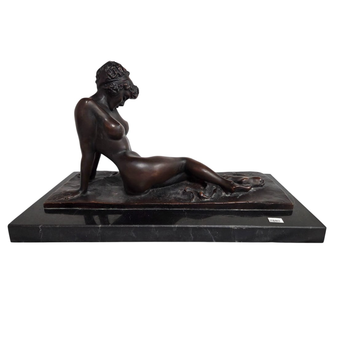 BRONZE OF A RECLINING NUDE WOMAN: Bronze sculpture of a woman reclining while leaning back on both arms. Signed lower left what appears to be WHARD. Measures 9.5" T x 17" W x 8" D. Condition good.