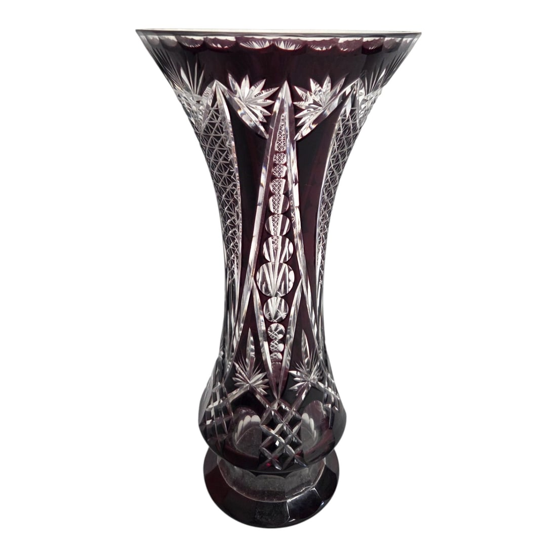 BOHEMIAN RUBY CUT TO CLEAR GLASS VASE.: Bohemian cased glass ruby cut to clear vase measuring 12" H x 6"W. Light inscription just above the base 'Cristiro' likely by a prior owner. SHIPPING NOTE: Live Auctioneers offers a very convenient