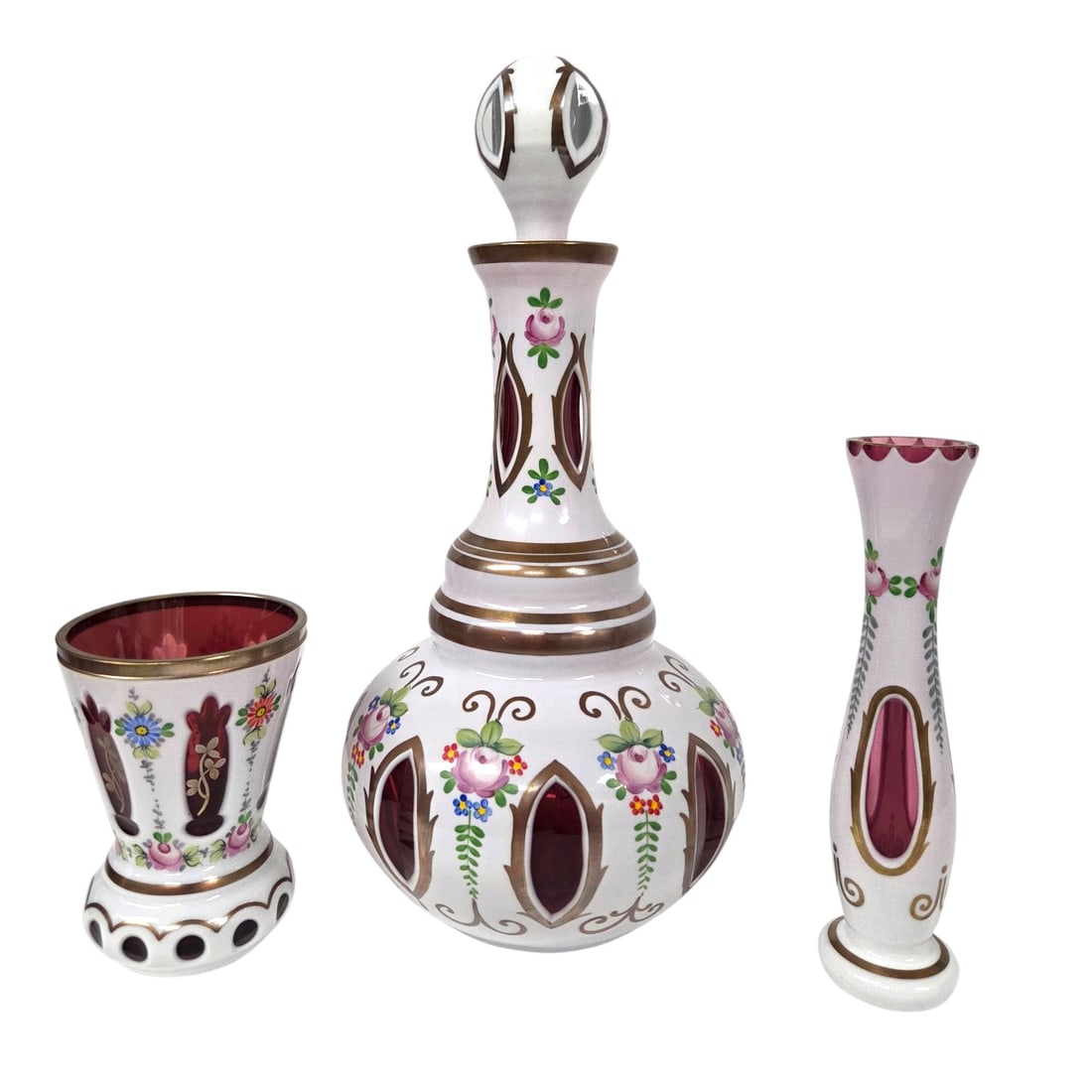 3 PCS OF BOHEMIAN GLASS RUBY & CRANBERRY TO CLEAR: Three cut Bohemian glass items. The first being a large decanter cut to ruby with a cut to clear glass stopper. 14" with stopper, 11" without and 6" wide. Then a dark cut to cranberry vase 5" x 3.75"