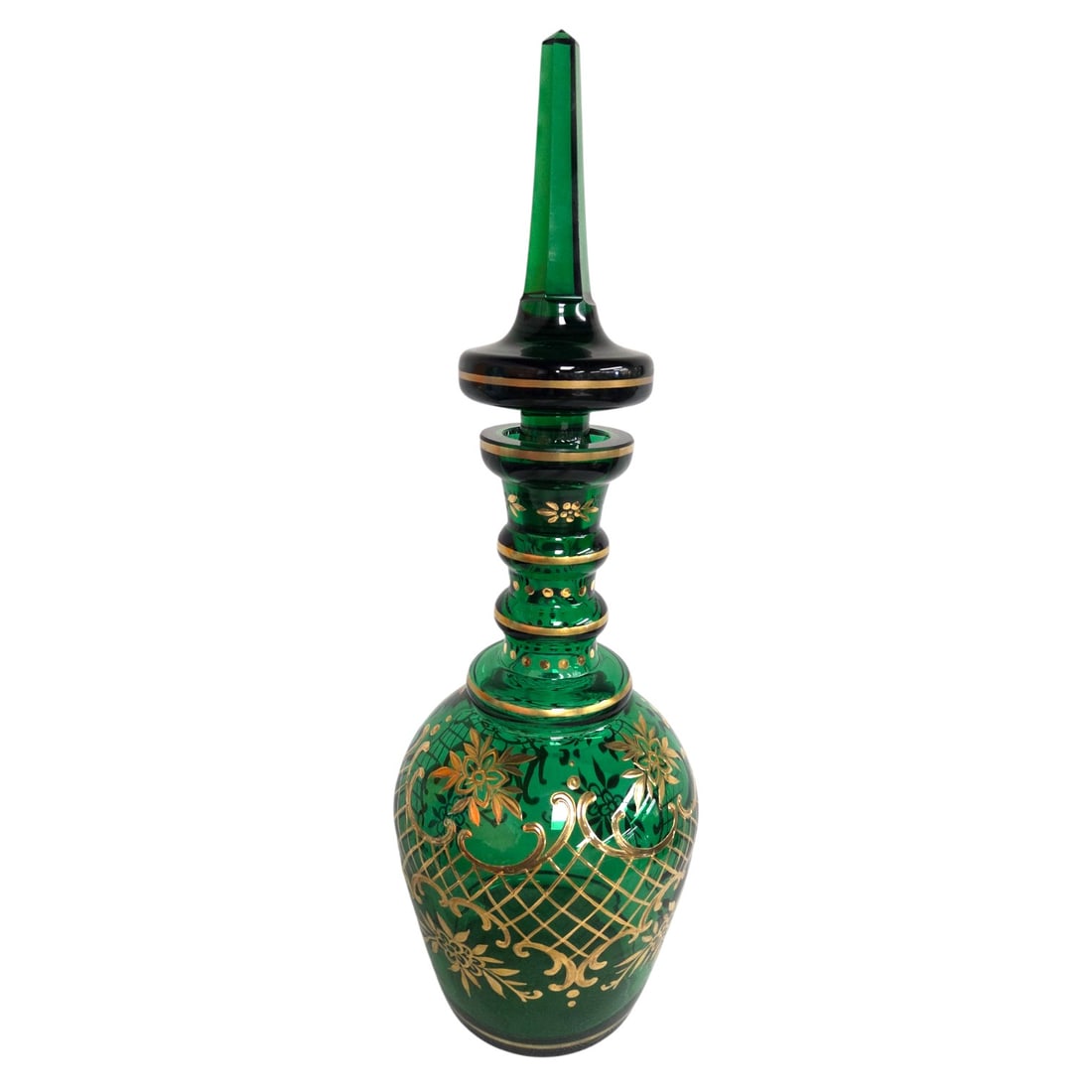 LARGE EMERALD GREEN GILT DECORATED DECANTER: A large deep emerald green glass Bohemian Style decanter with gold gilt enamel decoration. Measures 18.5" x 6.5". Good condition. SHIPPING NOTE: Live Auctioneers offers a very convenient shipping