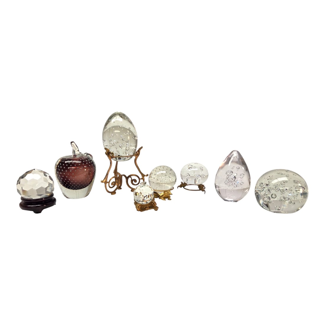8 GLASS PAPERWEIGHTS- KONST,TIFFANY & CO, CARTIER: Eight glass paperweights with 4 stands. One Konst, one Tiffany & Co, one Cartier, and 5 others (with no makers marks). Six "controlled bubbled" paperweights, and the other two are faceted "crystal