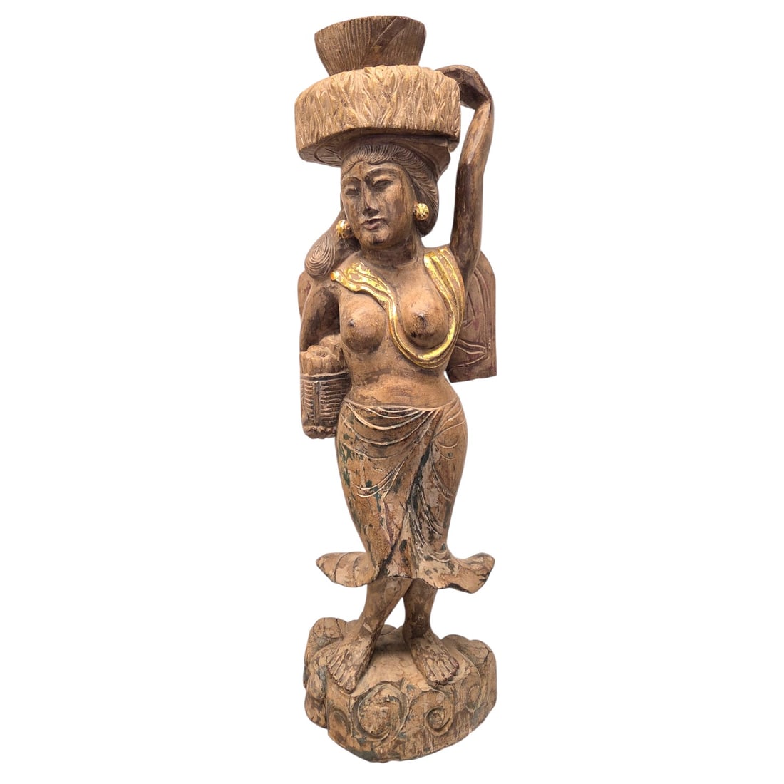 CARVED WOOD INDONASIAN WOMAN SCULPTURE: Carved wood sculpture of Indonesian woman with accents of gold and dark green undertones. Could be used as a pedestal. Measures 40.5"H x 13"W x 7"D. Good condition, but some cracks throughout. See
