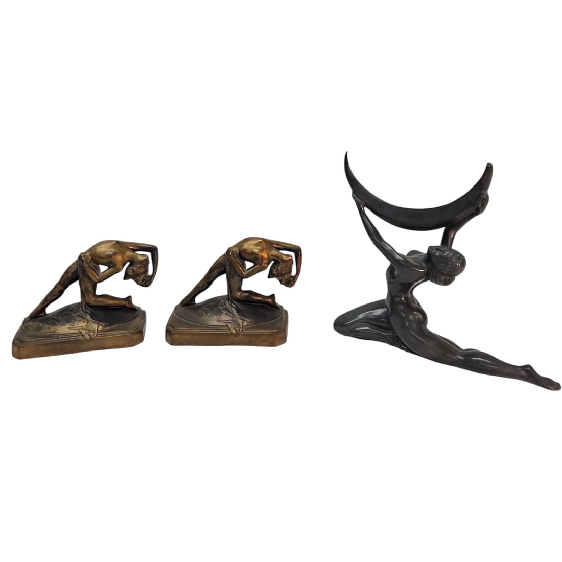 ART DECO BOOKENDS & FEMALE FIGURINE: This lot consists of a pair of art deco bronze bookends featuring a nude kneeling woman in an arched pose with 1 leg extended. Measures 5.5" H x 2.5" W. Good condition. A nude kneeling figurine holdin