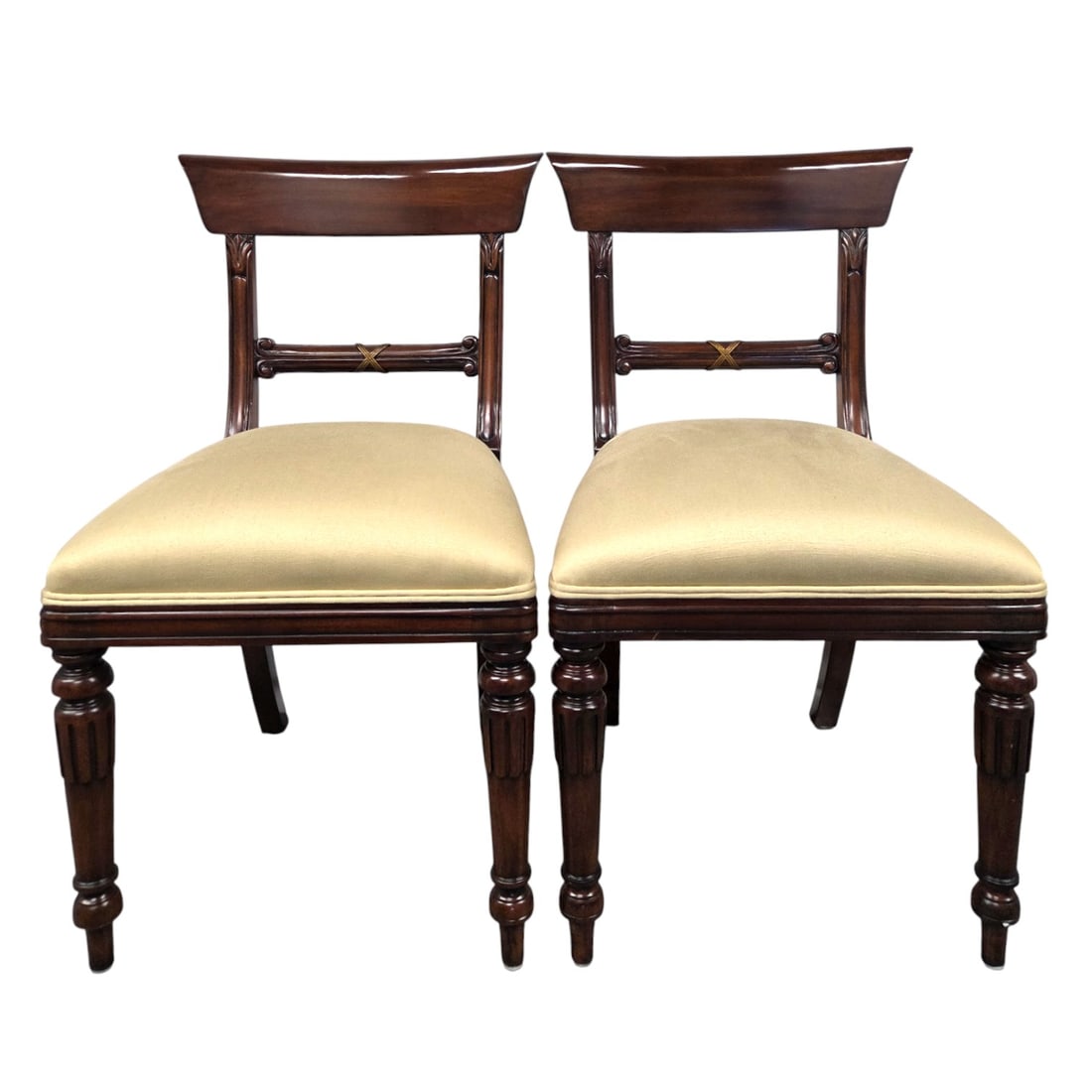 PR MAITLAND SMITH REGENCY STYLE SIDE CHAIRS: Pair of Regency style carved wood side chairs with cream/ ivory colored upholstered seats. Each measures 34.75" x 19.5" W x 17"D. Some wear due to use, and one has a small stain on fabric seat ( upper