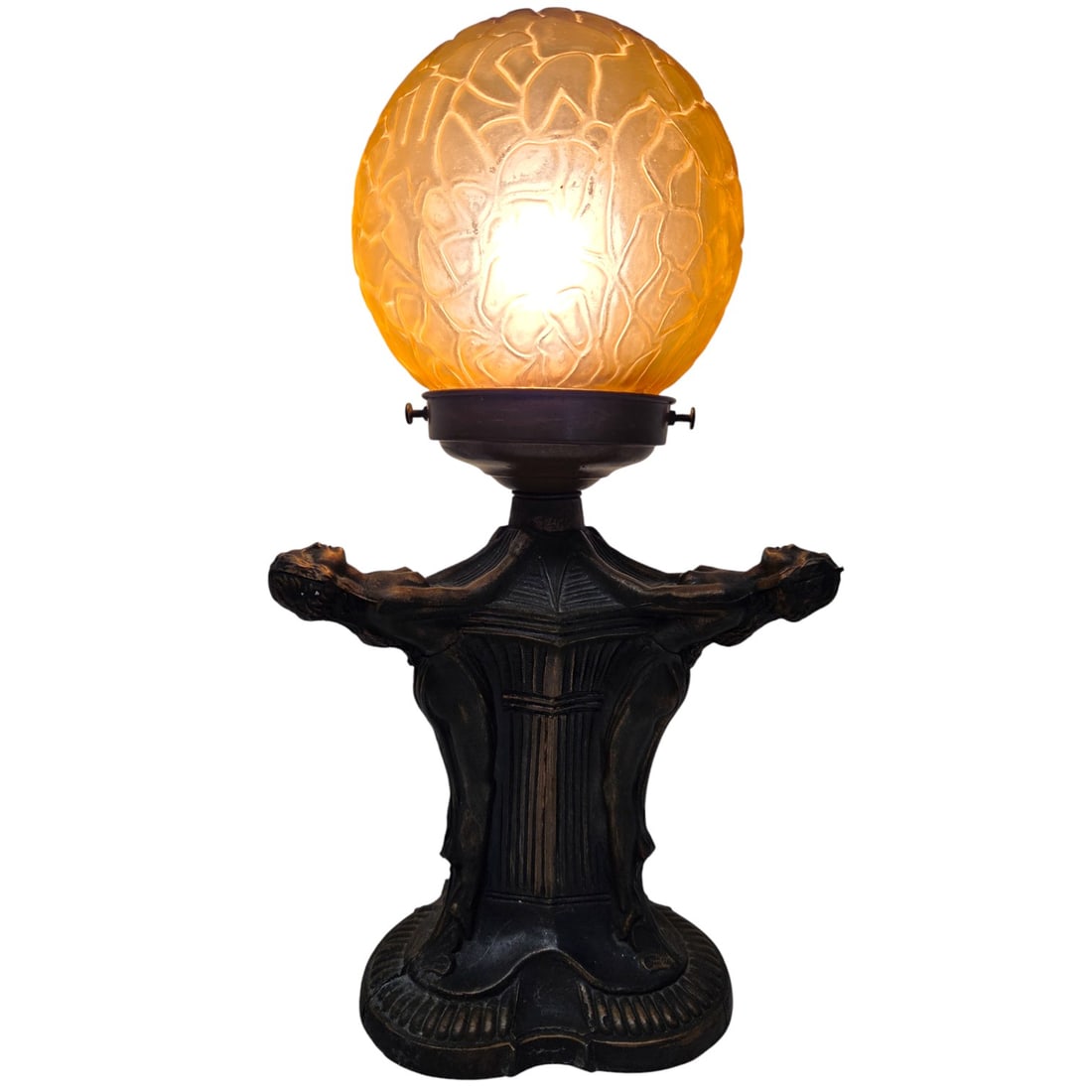 ART DECO 3 WOMAN NUDES- LAMP W/ AMBER GLASS: Art Deco lamp with 3 nude figures. Base is made of metal cast with bronze finish and amber glass ball. Lamp measures 13.5"H x 7" W x 8 "D. Lamp works and is in good condition. SHIPPING NOTE: Live Auct