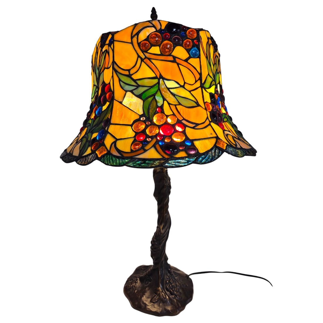 VINTAGE STAINED GLASS TABLE LAMP W/ GLASS JEWELS: A vintage stained glass table lamp with a nature inspired motif of grapes and leaves. Multi-colored stained glass panels as leaves and circular inlaid glass jewels as the grapes. Double socket. Bronze
