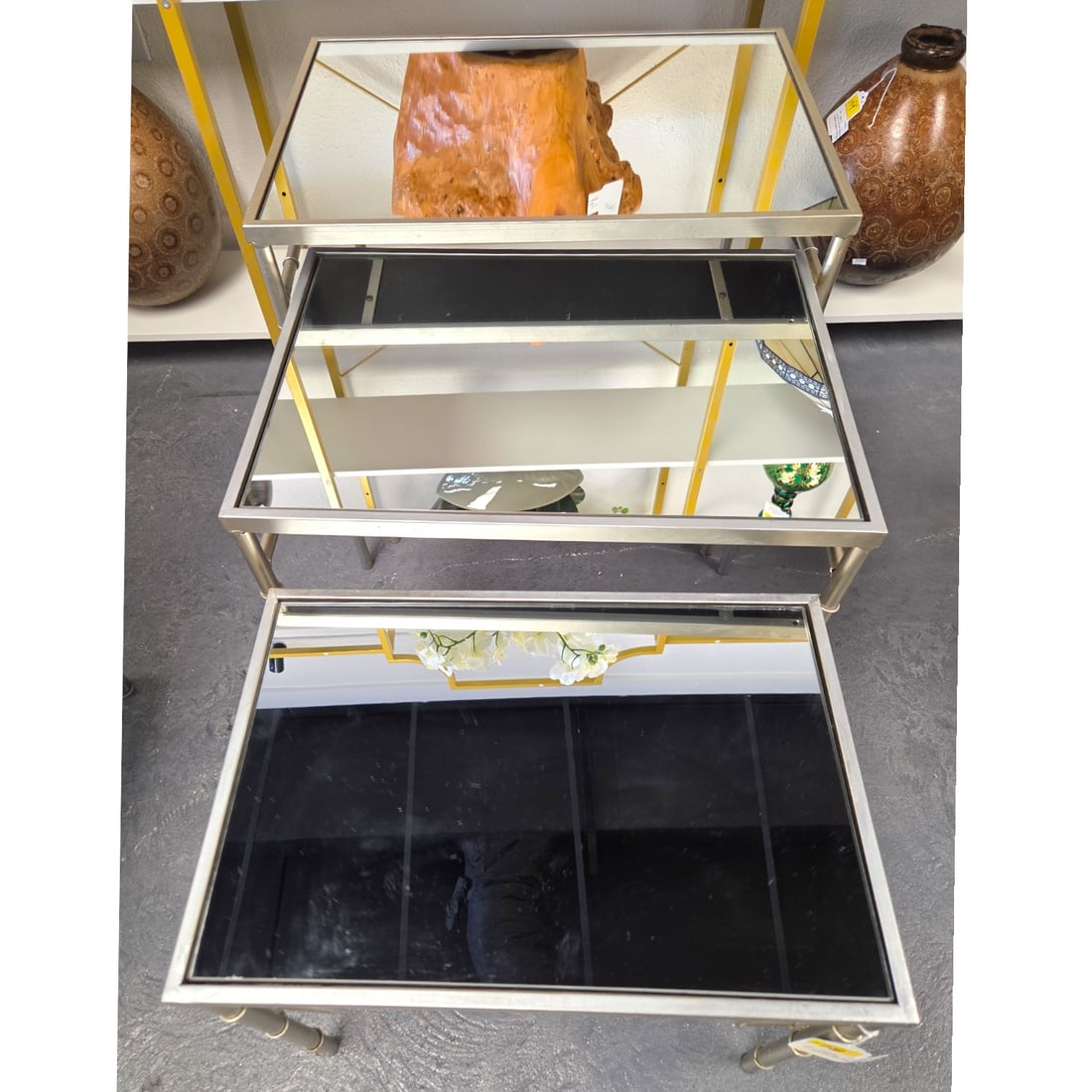 SET OF 3 NESTING TABLES: BAMBOO WITH PLATINUM FINI: Set of three nesting tables. Hollywood Regency-style. Bamboo style frames, mirrored tops, platinum silvery finish. Largest measures 22" x 22" x 15.5". Medium is 19.5 x 19.75 x 14.5", smallest is 12"