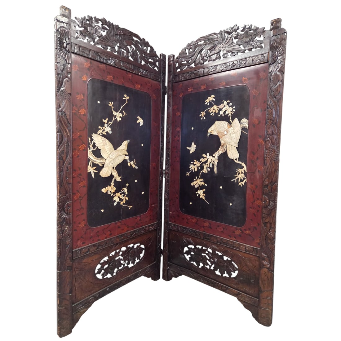 ASIAN CARVED WOOD 2 PANEL SCREEN W/ BIRDS: Asian carved wood two panel screen or room divider with intricate figures of birds and foliage. Measures 72" H x 68" W, each panel is 34" wide, and 1" thick. Chip on birds wing on right panel. See