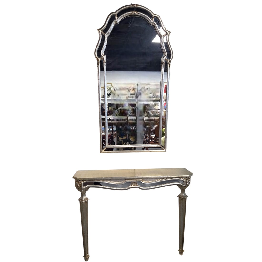 HOLLYWOOD REGENCY SILVER GILT CONSOLE AND MIRROR: Hollywood Regency style console and mirror. Complimentary but not matching. Small design elements differ. See images. Console with front and side mirrored panels and small fleur de lis decorative