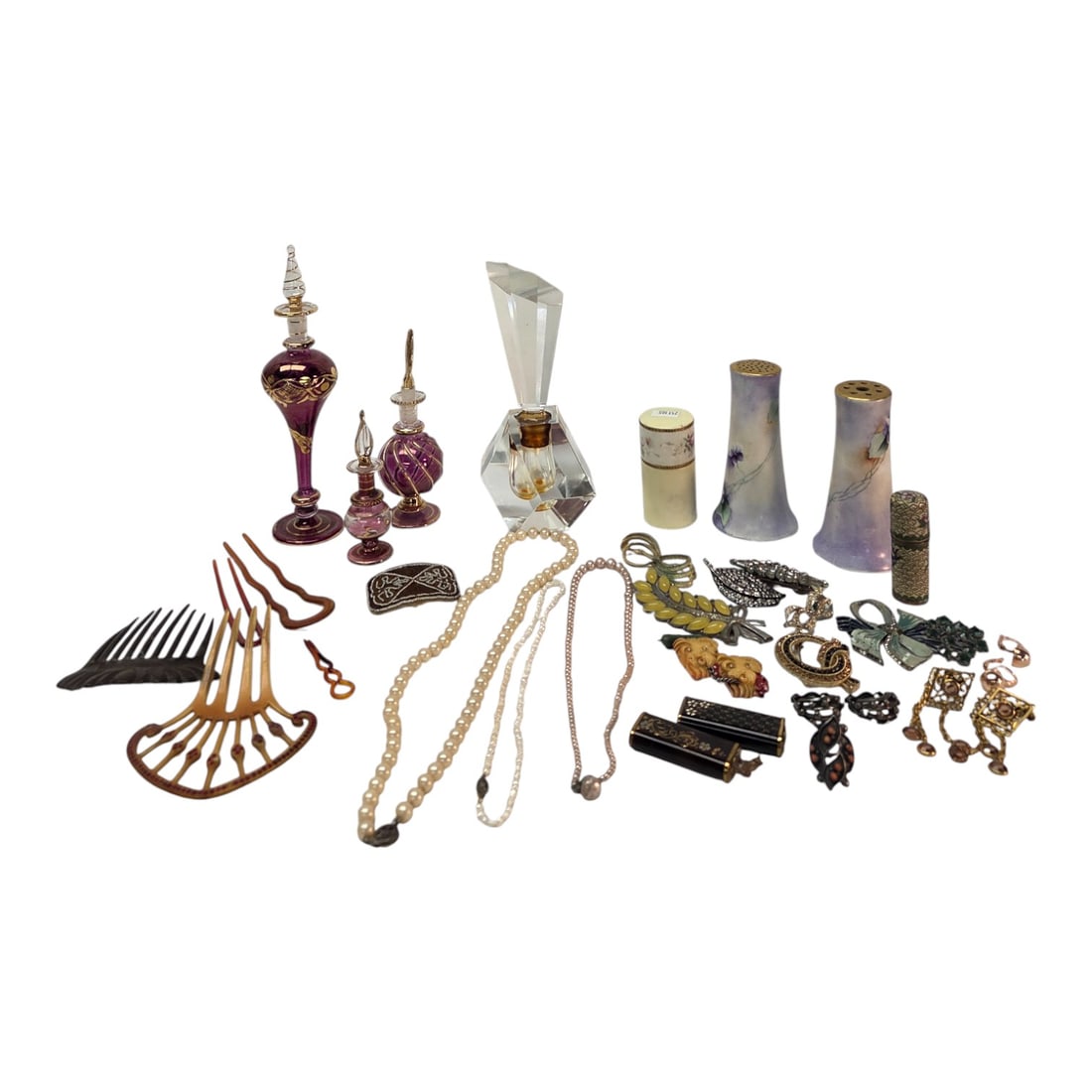 VANITY ITEMS-JEWELRY, PERFUMES, HAIR COMBS ETC.: A tray of vanity items consisting of celluloid hair combs, vintage costume jewelry, hatpin holders, and perfumes.Condition-some jewelry shows signs or wear, other items in good condition. SHIPPING