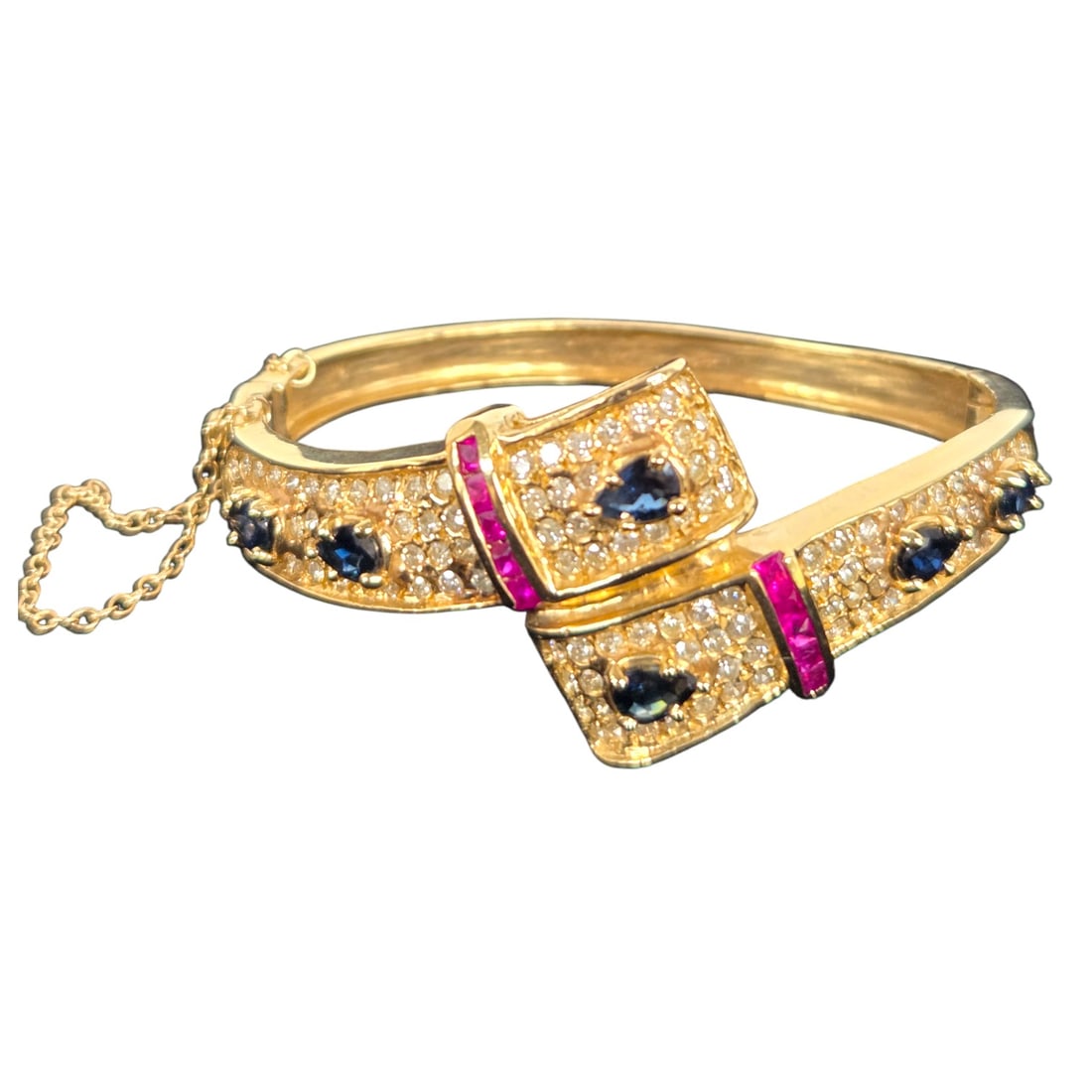 14kt GOLD BANGLE BRACELET w/ DIAMONDS SAPPHIRE RU: 14 kt yellow gold bangle bracelet with diamonds, sapphires, and rubies. 14K stamp on inside. Total weight is 29.37g. SHIPPING NOTE: Live Auctioneers offers a very convenient shipping option. For a sec