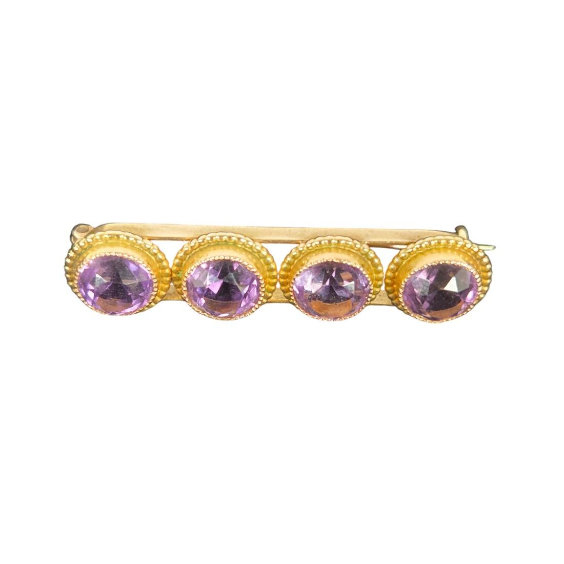 14K YELLOW GOLD AND AMETHYST BROOCH: 14K yellow gold and amethyst brooch, with 4 round amethyst stones. Measures 1.5" L x .25" W. Good condition, and acid tested for 14K. SHIPPING NOTE: Live Auctioneers offers a very convenient