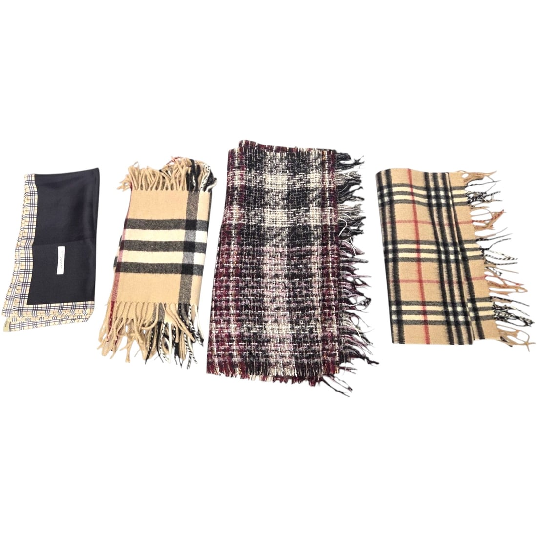 FOUR BURBERRY ITEMS: 3 SCARVES 1 POCKET SQUARE: A collection of four Burberry scarves including two 100% cashmere scarves made in England, one with fringe around the entire border measuring 53.5" x 8.5", and another with fringe on the ends only, me