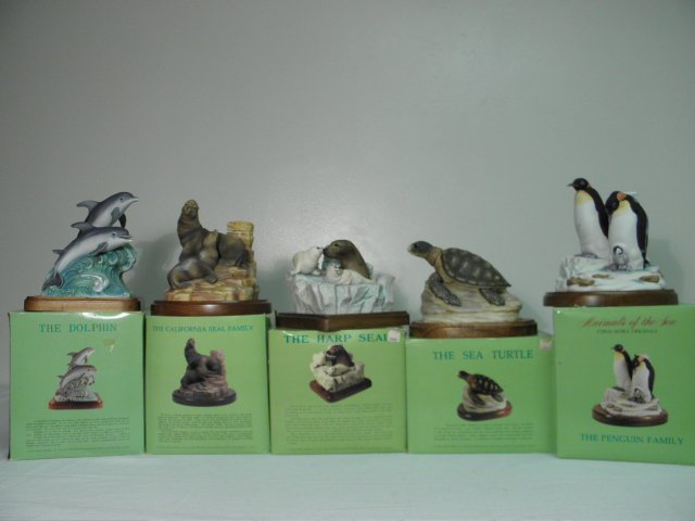 FIVE CYPRUS NOBLE FIGURAL PORCELAIN WILDLIFE DECANTERS: Five boxed Cyprus Noble figural porcelain wildlife decanters. Includes "The Penguin Family", "The Sea Turtle", "The Dolphin, "The California Seal Family", and "The Harp Seal". Condition: boxes show so