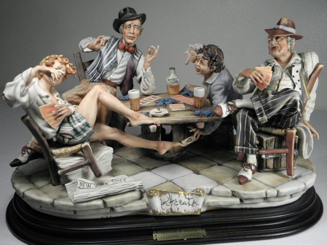 LAURENZ CAPODIMONTE PORCELAIN FIGURAL GROUP: Laurenz Capodimonte Italian porcelain figural group titled "The Four Cheaters". Mounted to a wooden carved base and marked on verso with "N" Capodimonte mark and "Made in Italy". Base is mounted with