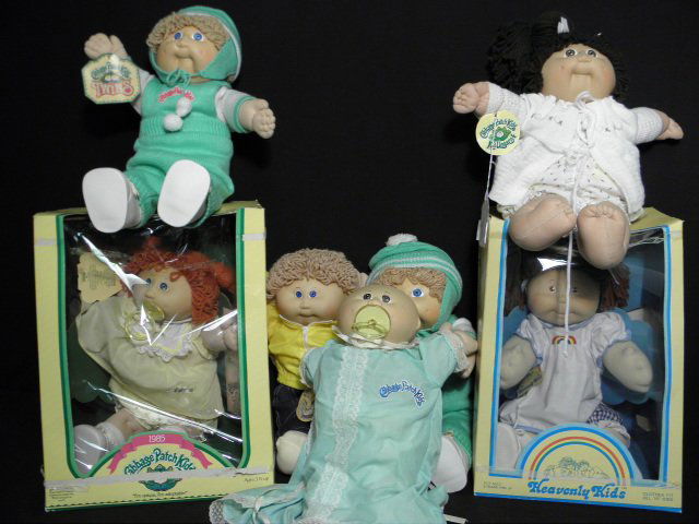 SEVEN VINTAGE CABBAGE PATCH KIDS DOLLS: Lot of seven vintage Cabbage Patch Kids dolls. Two boxed and five unboxed. Circa mid 1980s. Condition: generally good, wear to boxes, see images for details. Boxes each measure 14" tall, dolls each me