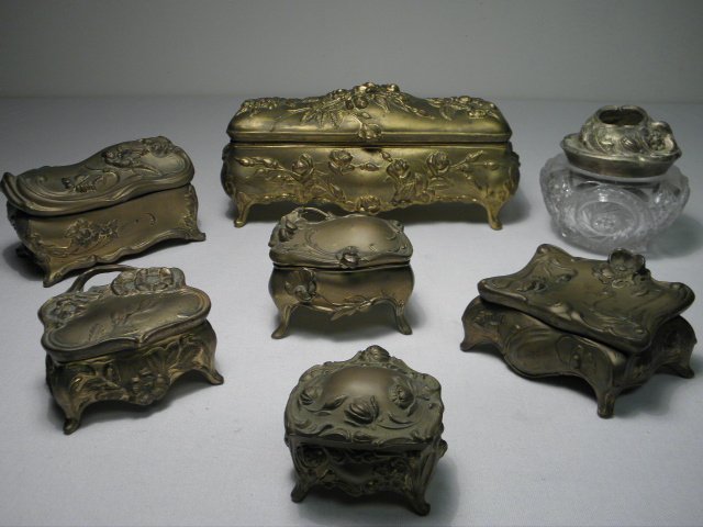 SEVEN ASSORTED ART NOUVEAU GILT METAL BOXES, ETC.: Lot of seven assorted Art Nouveau era gilt metal boxes and more. Includes a large jewelry casket by Brainard & Wilson, a medium casket decorated on the lid with a bird, two smaller unmarked trinket bo