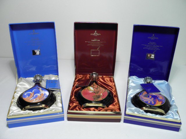 THREE ERTE COLLECTABLE COURVOISIER COGNAC DECANTERS: Lot of three boxed collectable Courvoisier cognac decanters designed by Erte. Includes "Edition No. 3 Distillation", "Degustation Edition No. 5", and "Vigne". Condition: all enclosed in original boxes