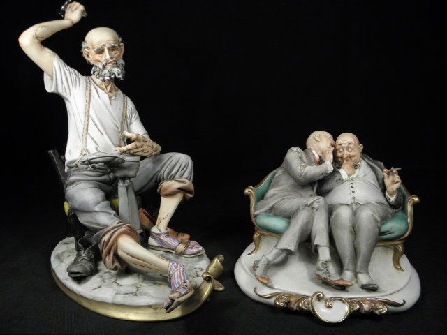 TWO ITALIAN PORCELAIN FIGURAL GROUPS: Lot of two Italian porcelain figural groups. The first is by Capodimonte and depicts a man repairing a shoe, the second is in the manner of Capodimonte and depicts two men sitting on a sofa. Condition