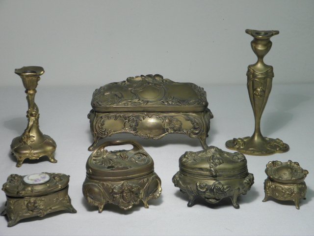SEVEN ASSORTED ART NOUVEAU GILT METAL BOXES, ETC.: Lot of seven Art Nouveau period gilt metal boxes, caskets, etc. Includes a larger Brainard & Wilson jewelry casket, four smaller footed boxes with hinged lids (one with hand painted porcelain insert),