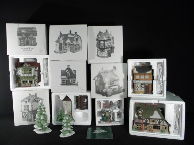 TWELVE "DICKENS' VILLAGE" LIGHTED PORCELAIN BUILDINGS: Lot of twelve assorted hand painted porcelain buildings from the "Dickens' Village Series", part of the Heritage Village Collection. Each includes a small light fixture which lights up the interior. I