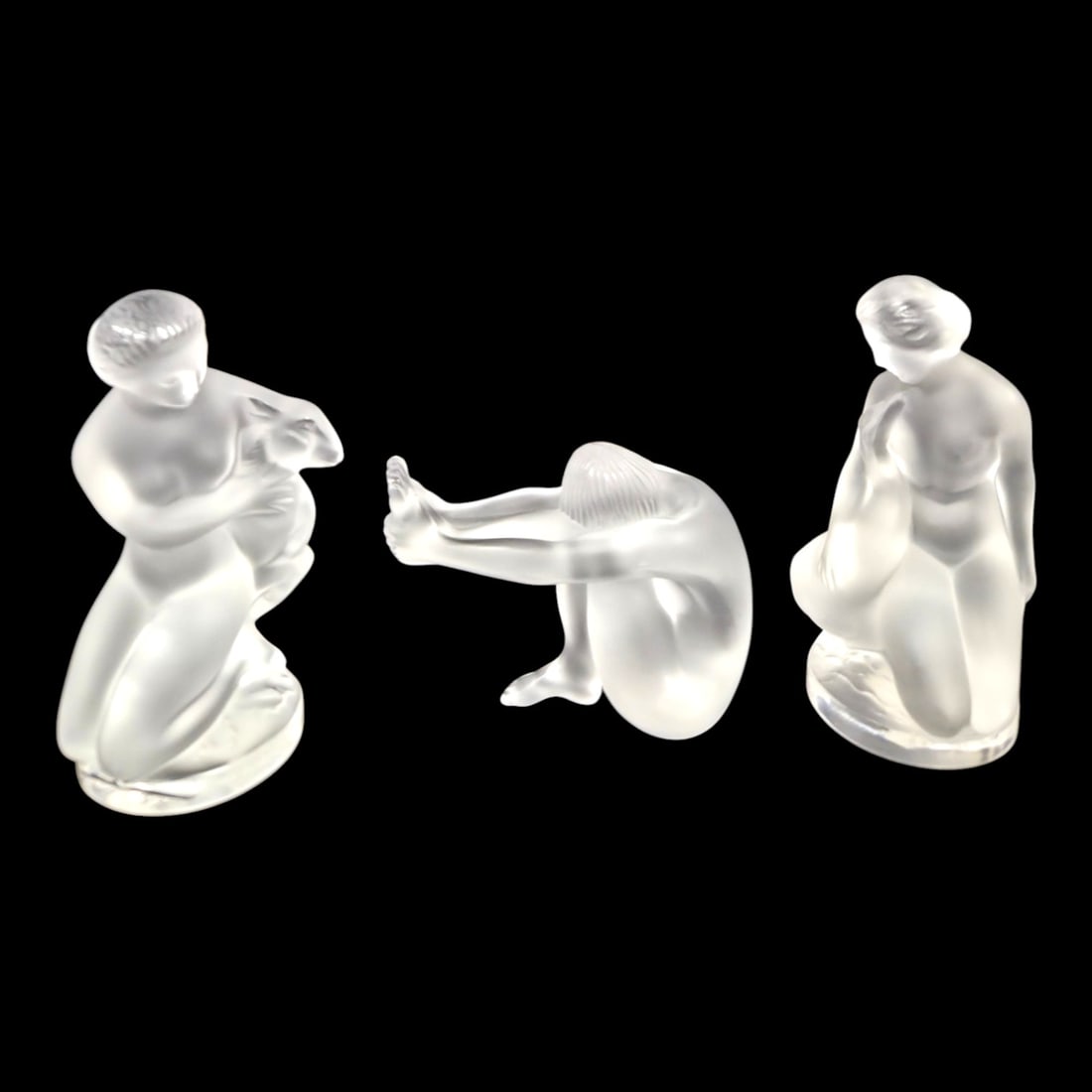 3 LALIQUE FROSTED GLASS FEMALE FIGURINES: Three Lalique frosted glass female figurines. Leda and the swan, Diana the Huntress, and Nu Tentation. All signed. Largest measures 5 H x 2.5 W. Good condition. See photos.