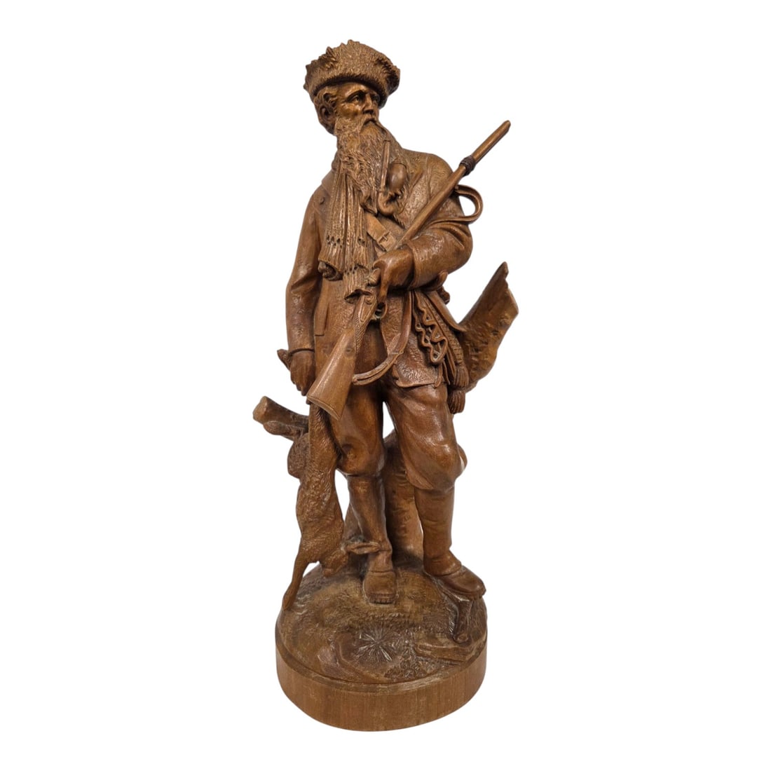 BLACK FOREST "HUNTER" WOOD CARVING: Fine Swiss Carved Lindenwood Figure of an Alpine Hunter, in the manner of Johann Huggler, Brienz, Switzerland, late 19th to early 20th century. The naturalistic sculpture realistically portrays a stan