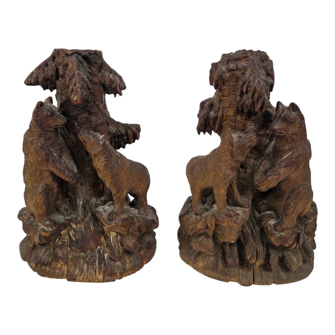 PR OF CARVED BLACK FOREST BEAR CANDLE HOLDERS: Pair of vintage carved Black Forest candle holders. Each features a rustic woodland scene of bears climbing trees. Both measure approximately 10.5 H x 7 W x 4 D. Good condition.