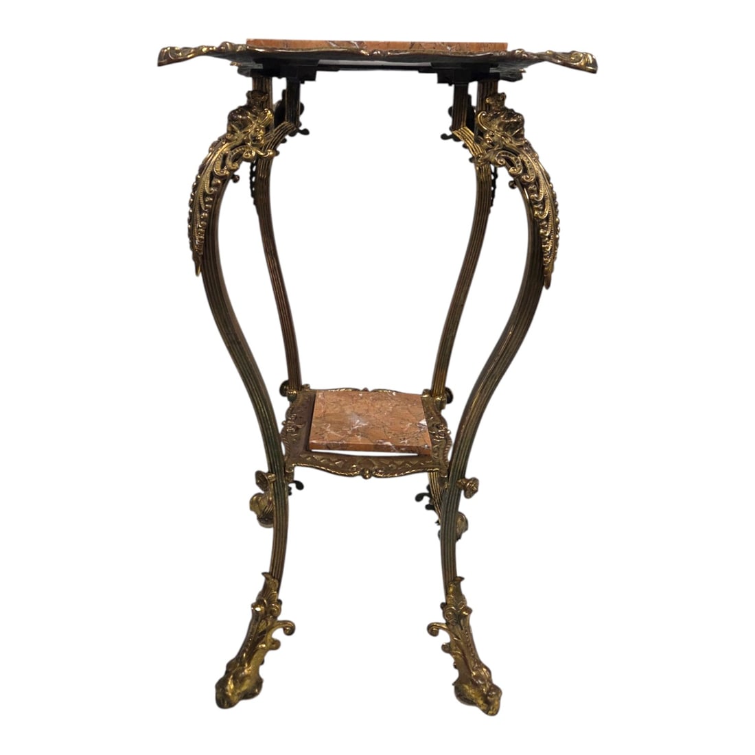 BRASS AND MARBLE TWO TIER PEDESTAL TABLE: Decorative brass and marble two tier pedestal table or plant stand. Features intricate cast brass work including motifs on legs and feet. Measures 30 H x 16 W x 16 D. Good condition. See photos.