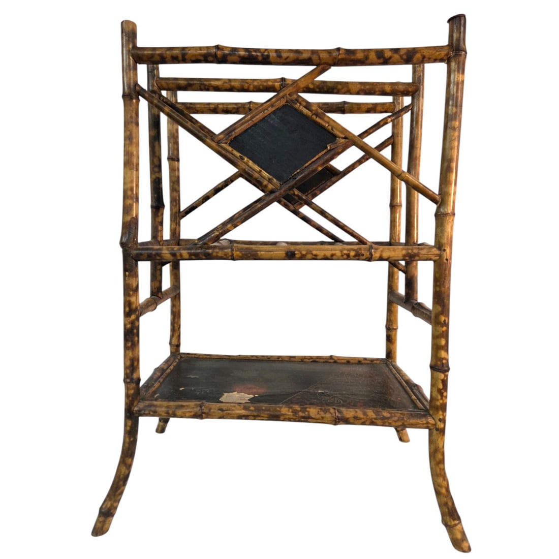 BAMBOO MAGAZINE RACK: Bamboo magazine rack featuring tortoise colored frame with two center black geometric panel accents, and painted floral base. This design incorporates cross braced bamboo deviders. Can also be used