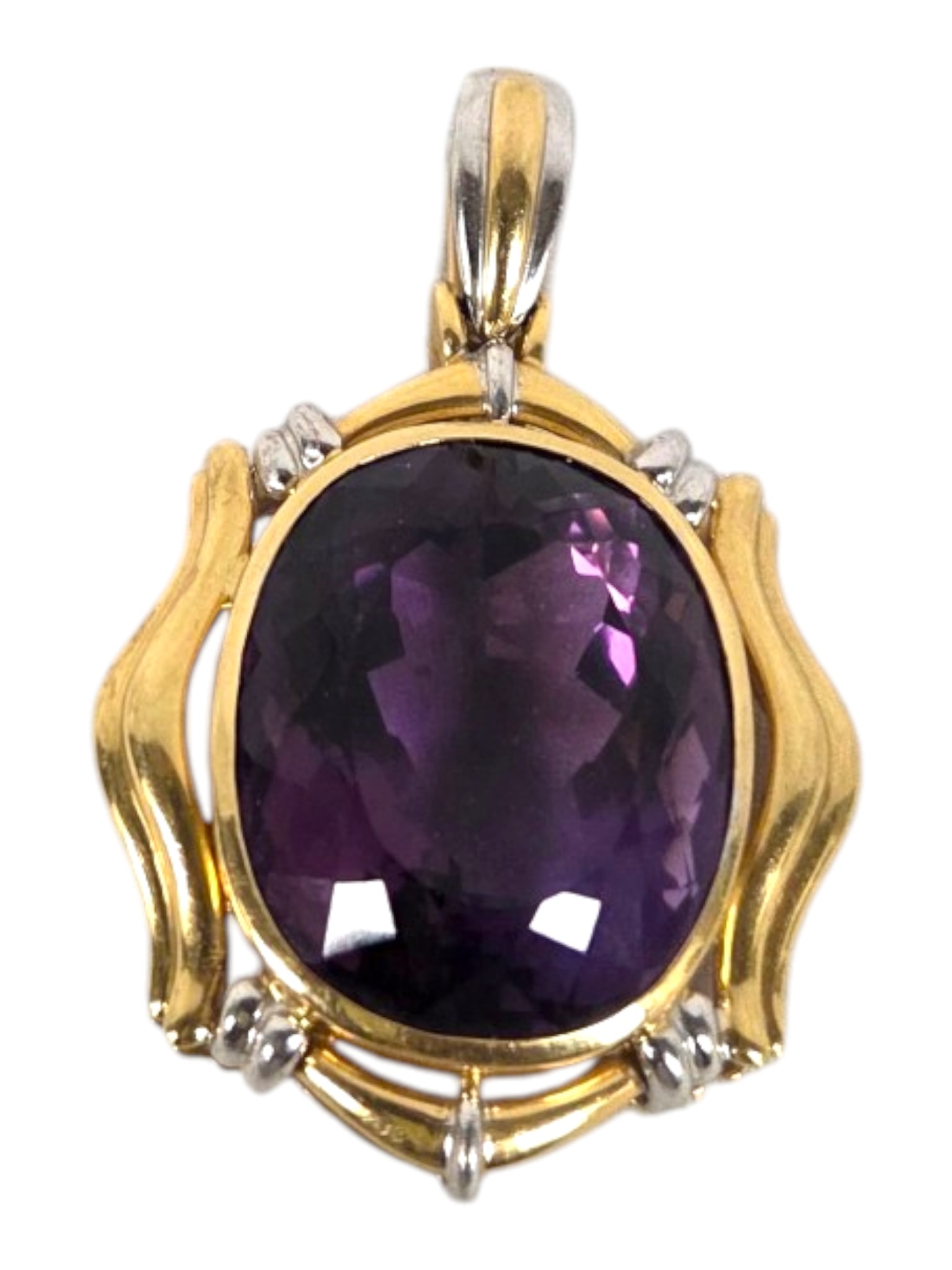 EXTRA LARGE 18 KT GOLD AND AMETHYST PENDANT: An estate 18kt yellow gold pendant bezel-set with an oval faceted amethyst weighing approximately 42.00 carats, displaying high clarity and exceptional brilliance. Total weight 36.66 grams. The 18kt