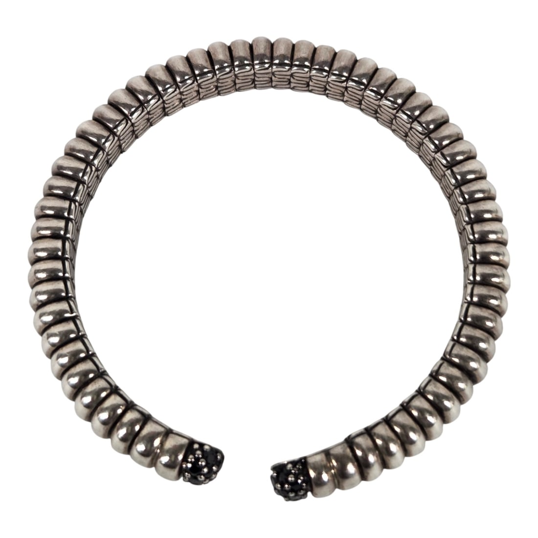 JOHN HARDY STERLING SILVER & SAPPHIRE FLEX BRACELET: John Hardy sterling silver flex cuff bracelet with pave-style black sapphires on each end. Stamped with JH logo on underside of one end and stamped 925 on the other. Good condition with intact stones 