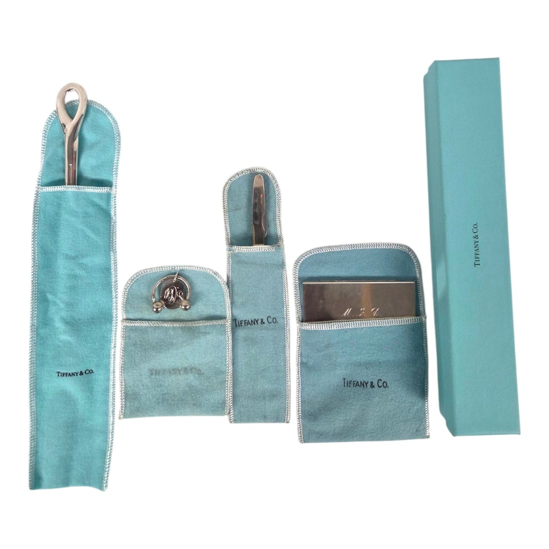 TIFFANY LETTER OPENER, KEY RING, KNIFE, CARD CASE: Four piece Tiffany sterling lot consisting of: (1) key ring monogrammed with MDJ . Measures 2 x 1.5 . Weight 12.06 grams. (2) Elsa Peretti Padova letter opener. Measures 9 . Weight 82.40 grams.(3) Car