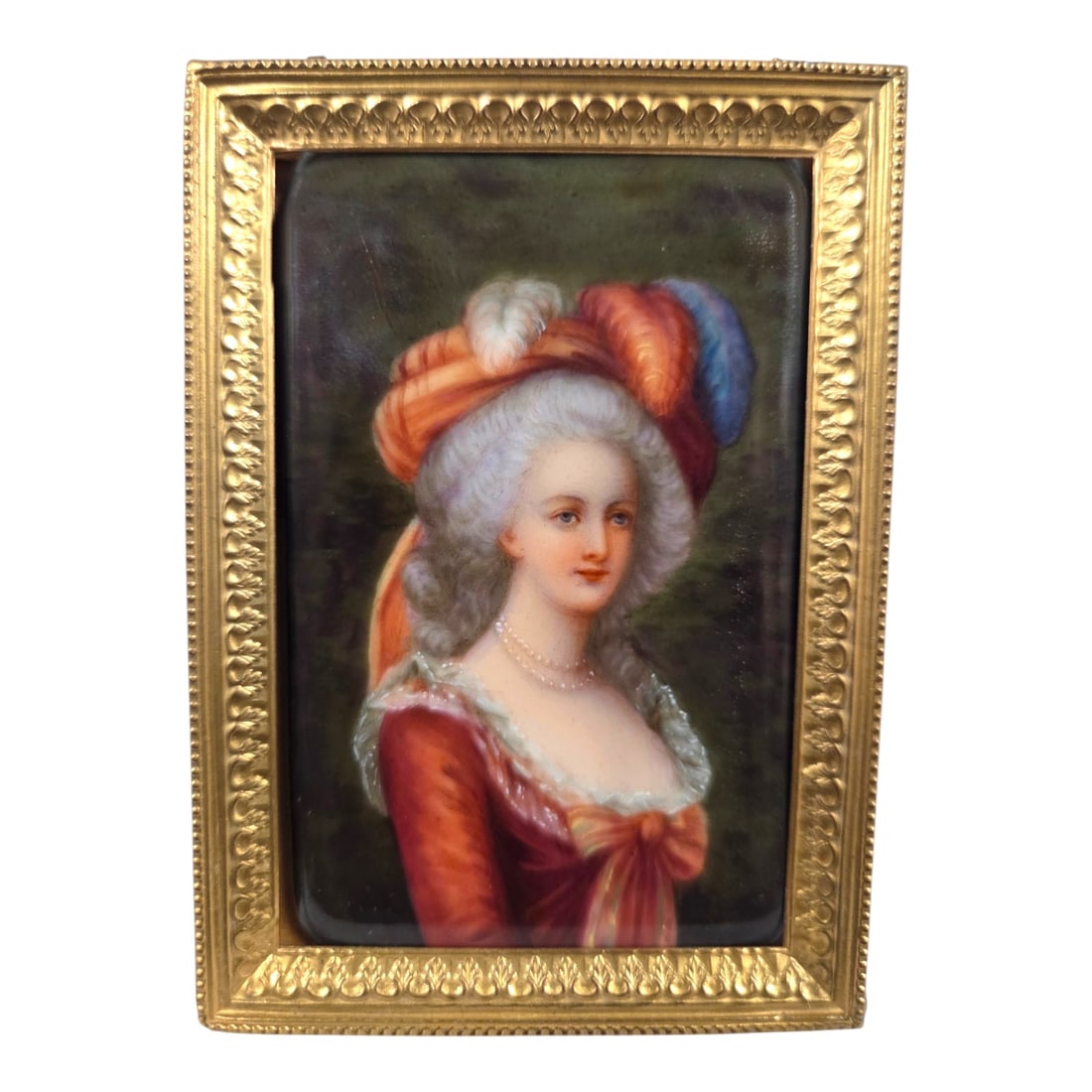 MINIATURE PAINTING MARIE ANTOINETTE IN CRIMSON: Miniature hand-painted on porcelain plaque portrait of Marie Antoinette modeled after the royal portraits created by Elisabeth Vigee Le Brun. No artist signature. Inscription on back reads Painted in