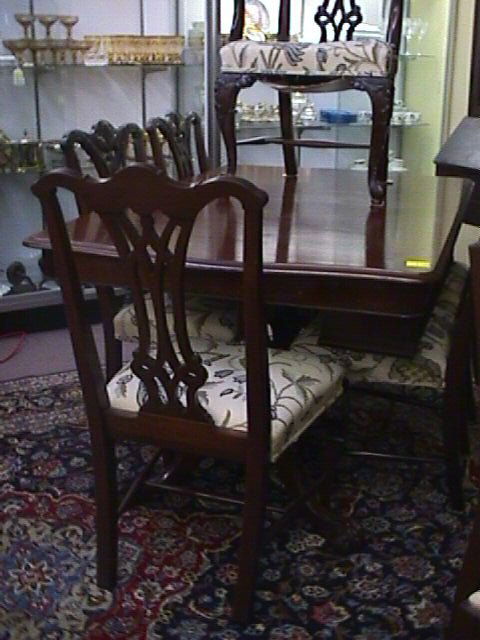 CHIPPENDALE STYLE MAHOGANY DINING SET: CHIPPENDALE STYLE MAHOGANY DINING SET Dining table has three leaves measuring 10" wide x 42 1/2" deep, table 66 1/2" wide, 1 arm chair and 5 side chairs. Upholstered crewel work seats.