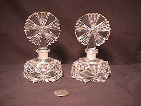 PR CUT CRSYTAL PERFUME BOTTLES: Each bottle measures 5 1/2" high x 3 1/4" wide. Small chip on bottom of one bottle. One rim has chips and glass is sick. Overall good condition.
