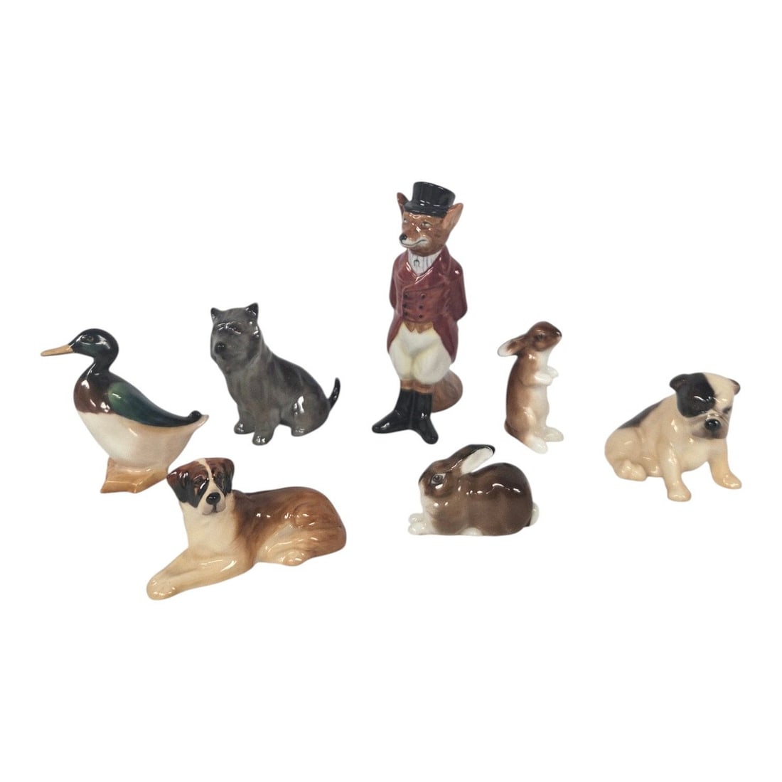 7 ROYAL DOULTON PORCELAIN ANIMAL FIGURINES: Lot consists of 7 vintage Royal Doulton porcelain miniature animal figurines. 3 dogs, 1 duck, 2 bunnies, and one Huntsman Fox . Each piece is beautifully hand-painted with fine glaze, vibrant colorati
