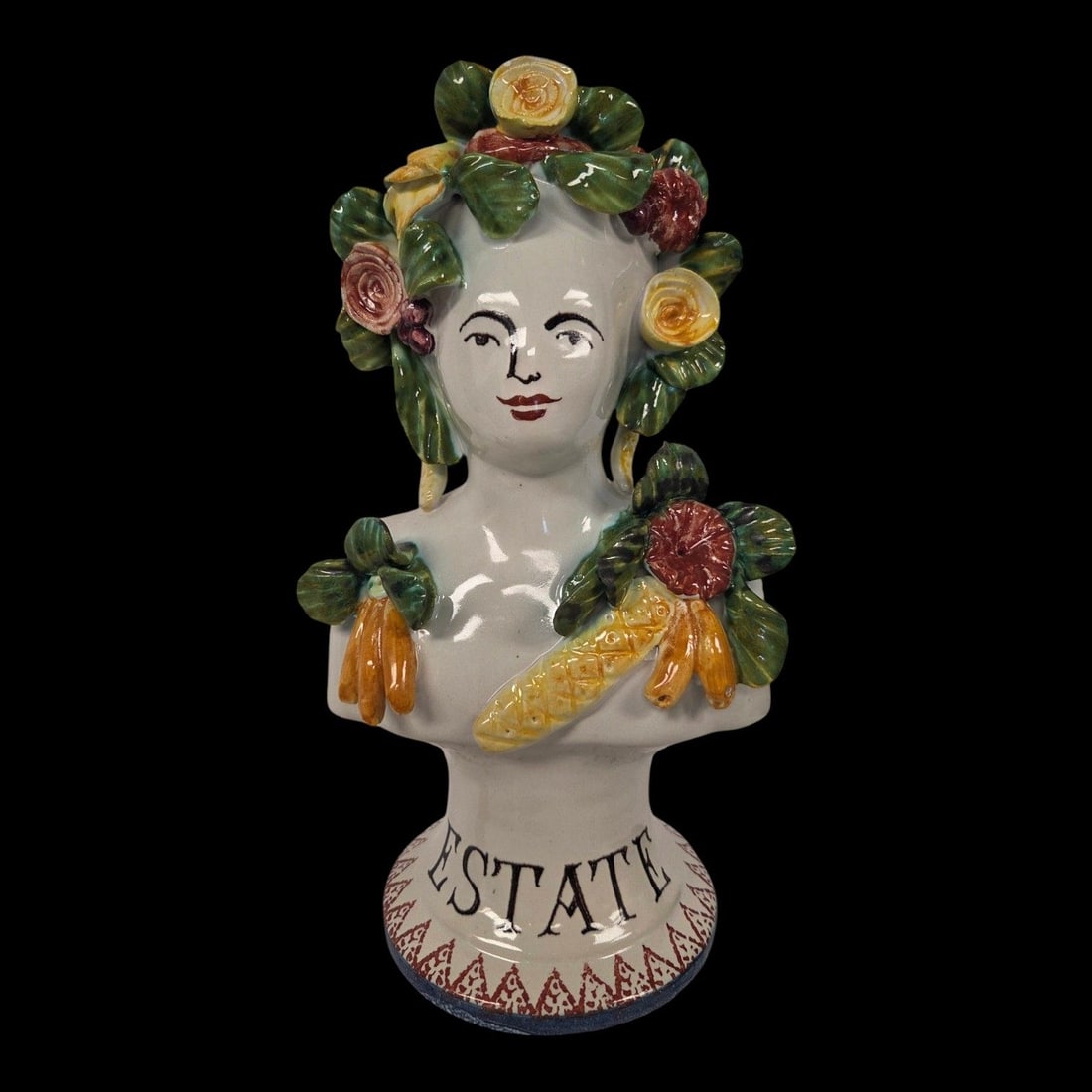 ITALIAN MAJOLICA BUST "ESTATE": A hand-painted Italian Majolica bust or head vase with the inscription Estate (Summer). It features the bust of a woman heavily embellished with colorful fruits, flowers, and vegetables. There is a st