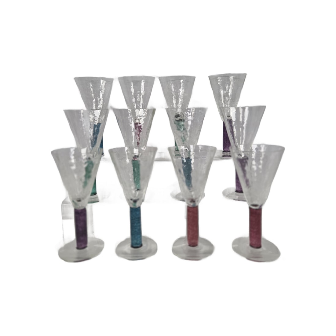 UNION STREET GLASS SET OF 12 STEMS: This lot consists of 12 goblets with jewel-toned colored stems and crackle glass. All pieces are etched with artist signature and production date. Each one measures 7.5 tall. Condition is very good