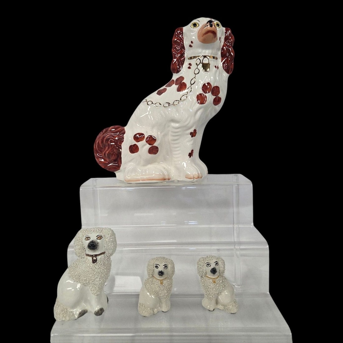 4 ENGLISH STAFFORDSHIRE DOGS: This lot consists of a large 11.5 Wally dog with handpainted red and white markings and a gold chain and lock. The bottom is stamped England with the numbers 4561. Measures 11.5 h x 8 w x 3.5 d.