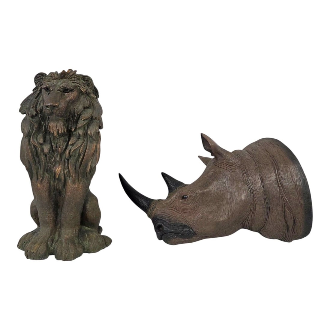 2 ANIMAL FIGURINES OF WALL RHINOCEROS & SITTING LION: Lot consisting of one large Rhinoceros Head decorative wall decor made from a poured resin mold. Measures 20 H x 10 W x 17 D, and one sitting Lion carved from plaster, and painted with an antique