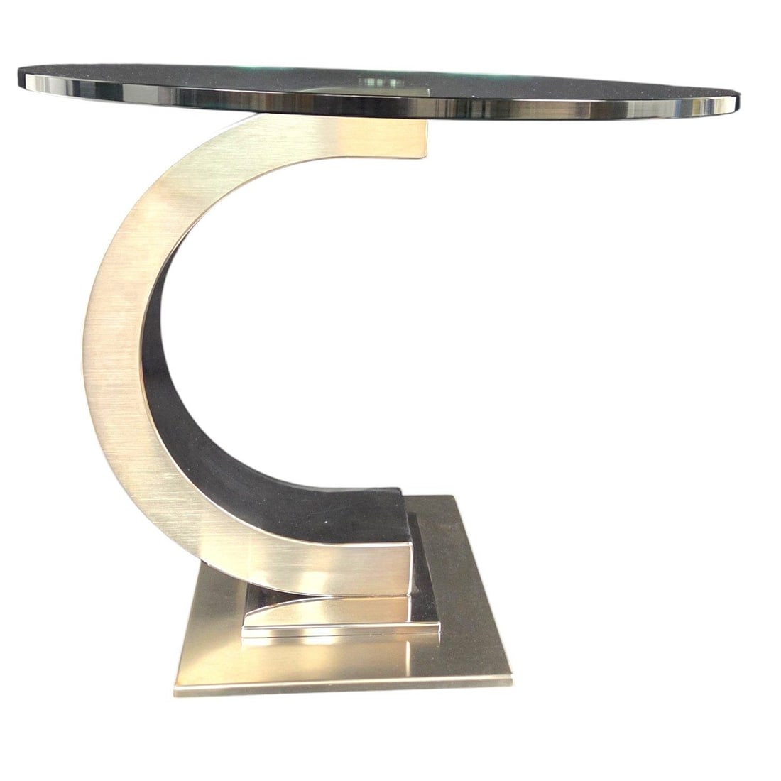 CURVED MODERNIST CHROME & GLASS ROUND SIDE TABLE: Curved Modernist chrome and glass top side table featuring a round tempered glass with a classic polished edge. The pedestal has a dynamic C- shaped which offers architectural stablitiy. Note: glass