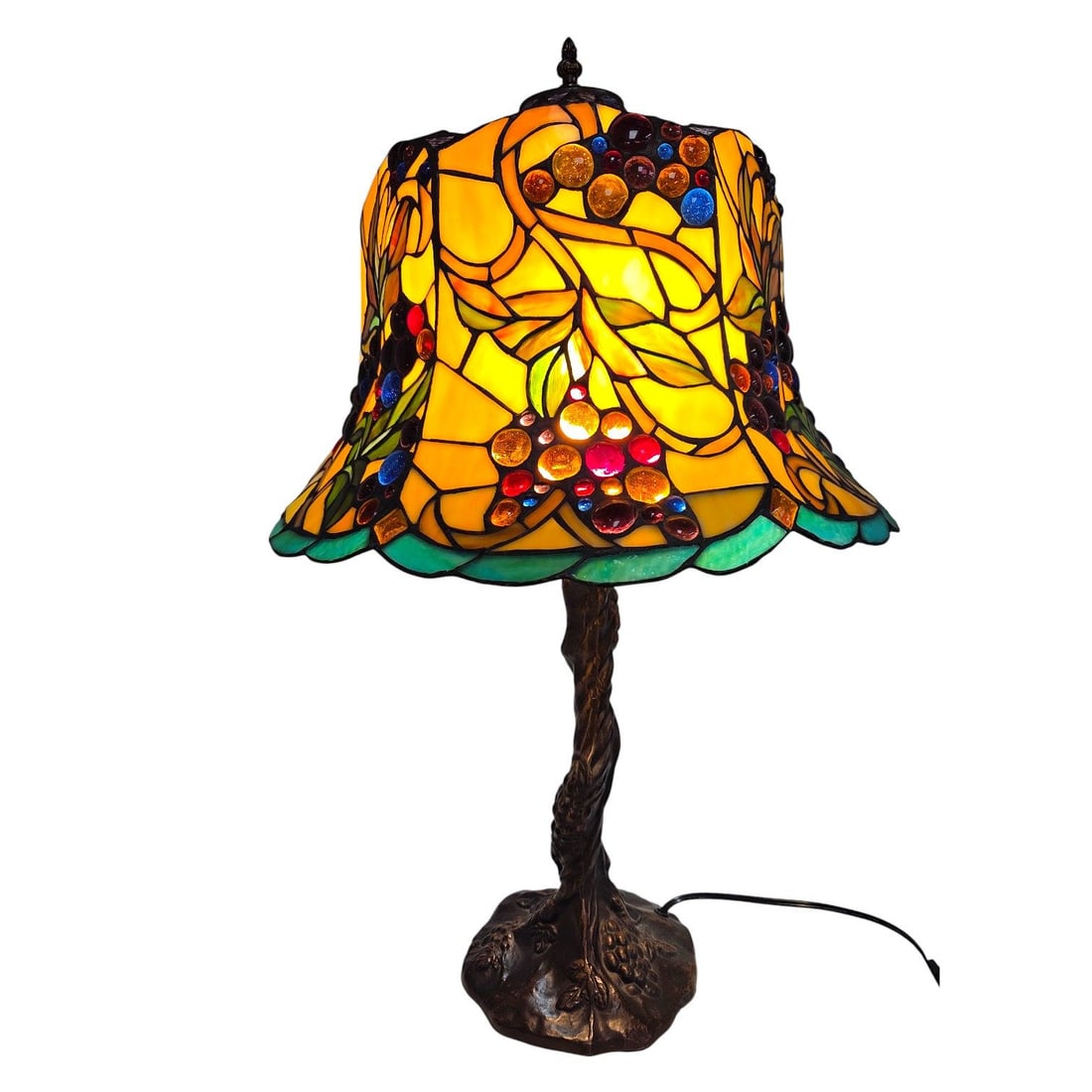 VINTAGE STAINED GLASS LAMP WITH GLASS JEWELS: A vintage stained glass table lamp with a nature inspired motif of grapes and leaves. Multi-colored stained glass panels as leaves and circular inlaid glass jewels as the grapes. Double socket. Bronze