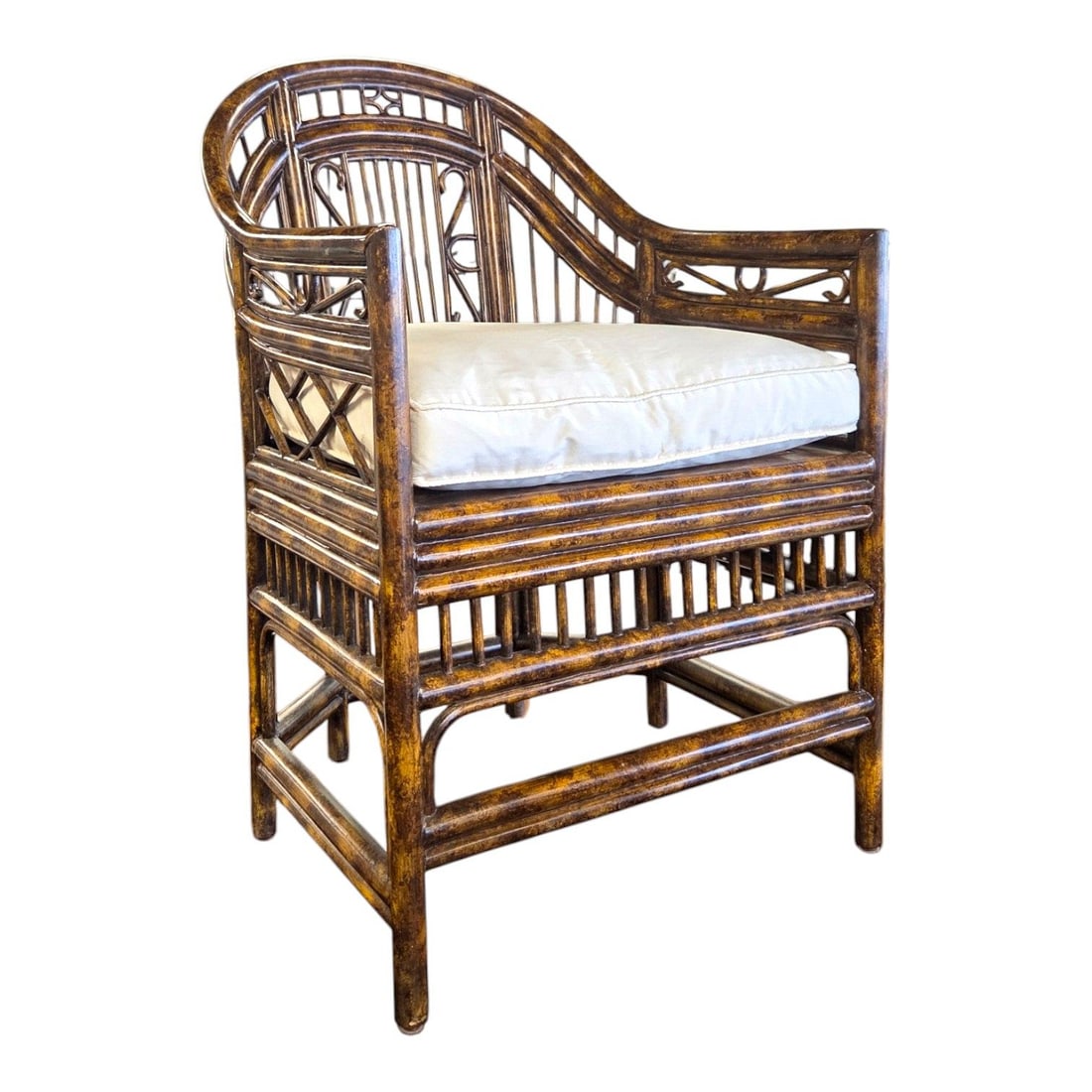 MAITLAND-SMITH PAVILION STYLE ARM CHAIR: Maitland- Smith Pavilion style arm chair. Featuring a faux tortoiseshell finshed frame, and cream/ ivory colored silk blend down feathered pillow. This design showcases geometric open fretwork on the